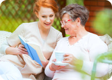 caregiver reading a book to patient