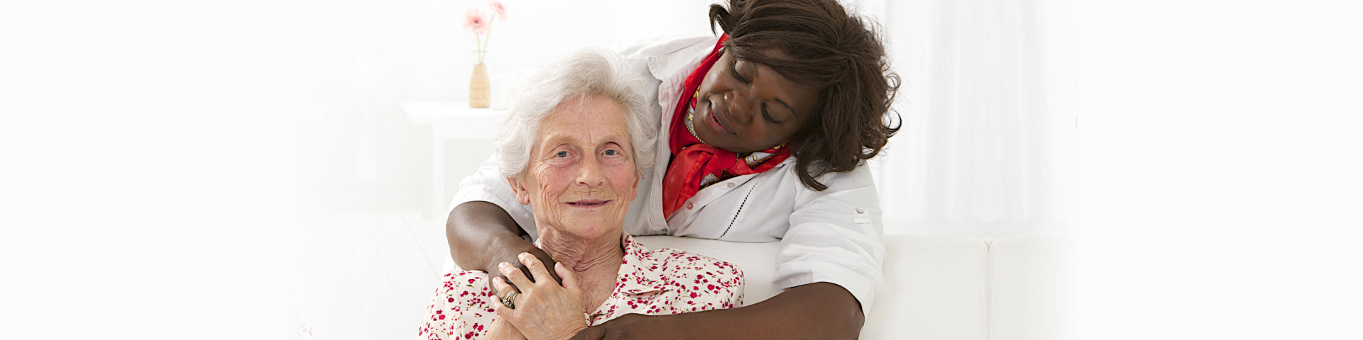 caregiver hugging the elder lady