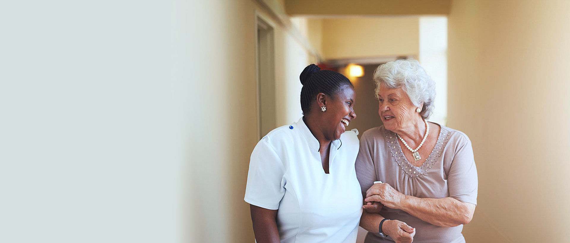 caregiver and patient looking at each other while smiling